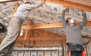 Men working on garage insulation