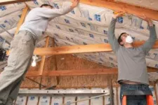 Men working on garage insulation