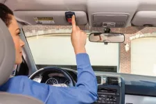 Woman opening a garage door form her car