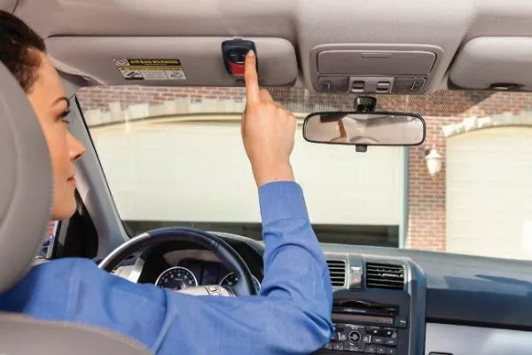 Woman opening a garage Door from her car